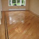 Skilled craftsman laying hardwood floors - Oil and water base finishing - Floor Solutions NY